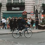 man cycling on street in london