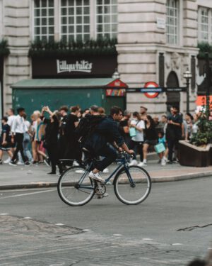 man cycling on street in london