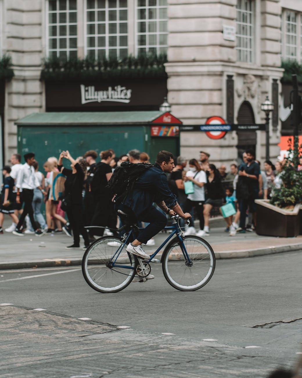 man cycling on street in london