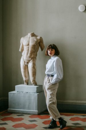 woman standing beside sculpture