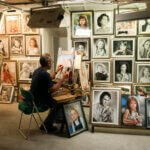 man sitting on chair painting inside room